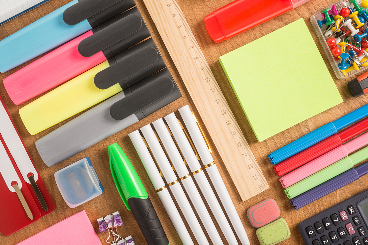 Colorful writing utensils including highlighters, pens, markers, sticky note pads, and more